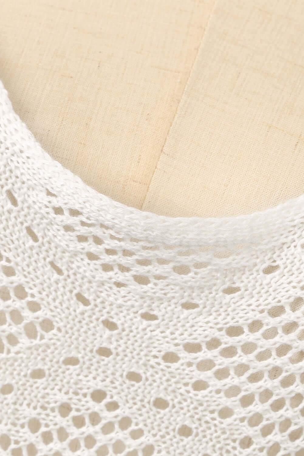 Close-up of the neckline of a Tassel Openwork Spaghetti Strap Cover Up Dress in white acrylic fabric.