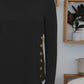 FAM-FAM Round Neck Long Sleeve T-Shirt in black with decorative buttons, perfect for adding playful elegance to any casual outfit.