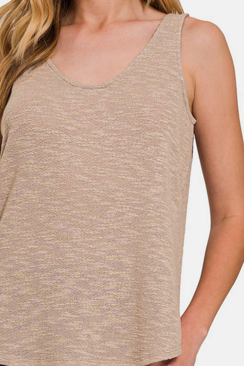 Woman wearing a beige Curved Hem Round Neck Tank, perfect for summer casual outfits with denim shorts or skirts.