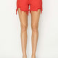 High Rise Distressed Denim Shorts in vibrant red with a flattering high waist and edgy distressed hem from Risen Jeans.