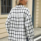 Woman wearing Bella Road plaid collared long sleeve jacket standing outdoors