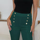 Woman wearing FAM-FAM High Waist Skinny Pants with decorative buttons in green, showcasing elegant and versatile style.