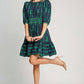 Stylish woman in a frill contrast velvet trim half sleeve dress with ribbon print, perfect for special occasions.