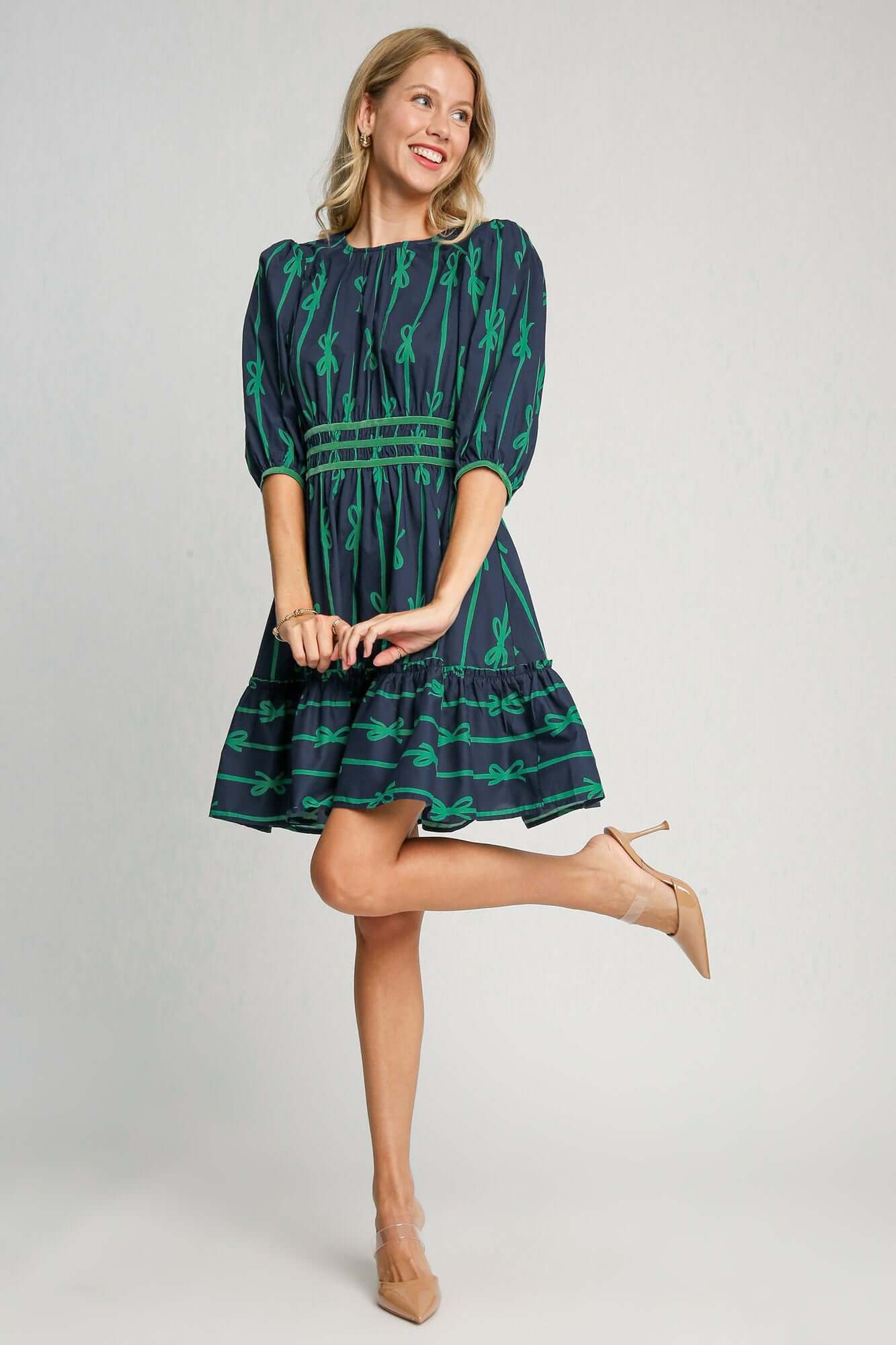 Stylish woman in a frill contrast velvet trim half sleeve dress with ribbon print, perfect for special occasions.