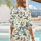 Stylish woman in pastel yellow tassel cover-up showcasing floral print by a pool under a sunny sky.