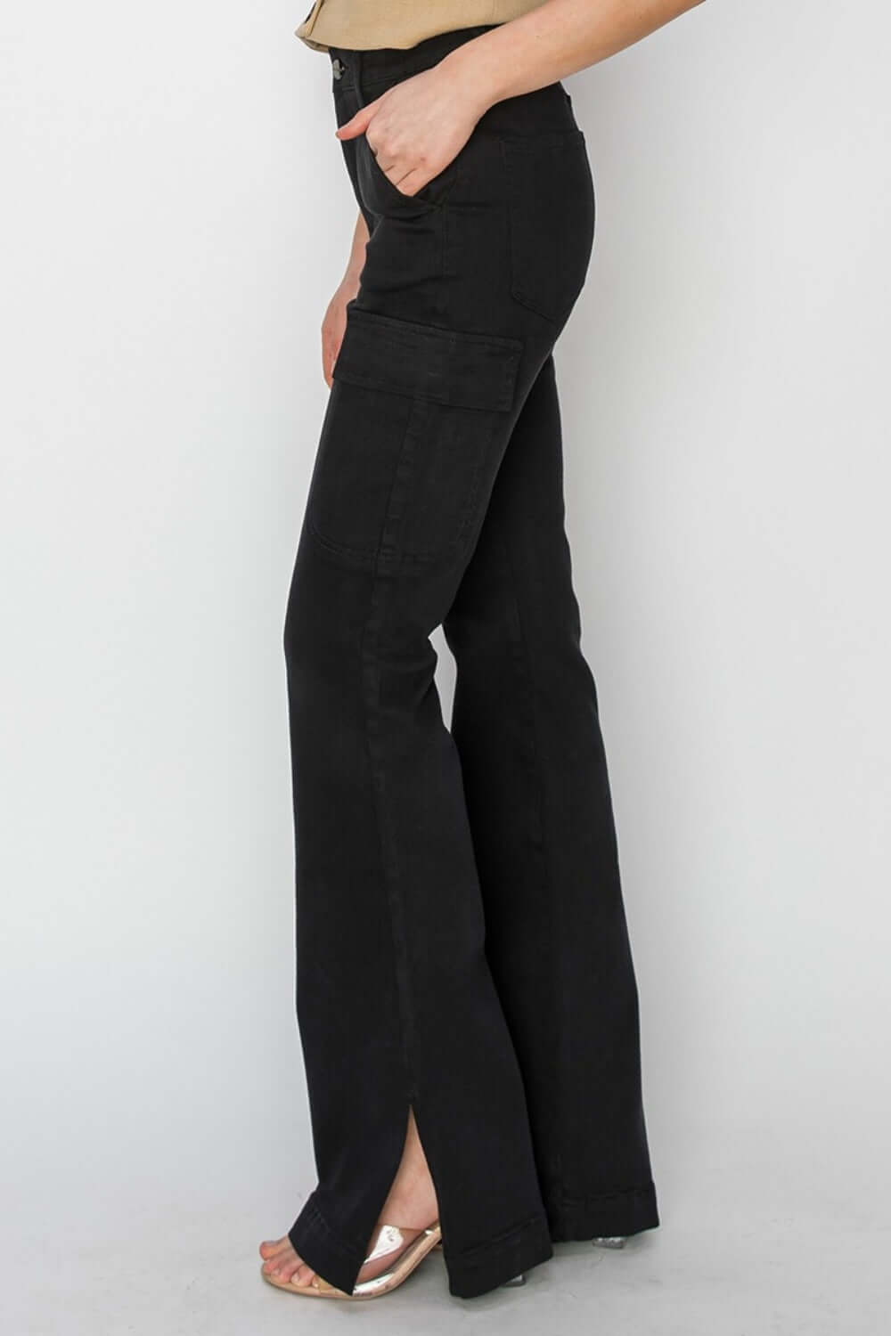 Black high-rise side slit cargo bootcut jeans by Risen Jeans with a flattering high waist and edgy side slits.