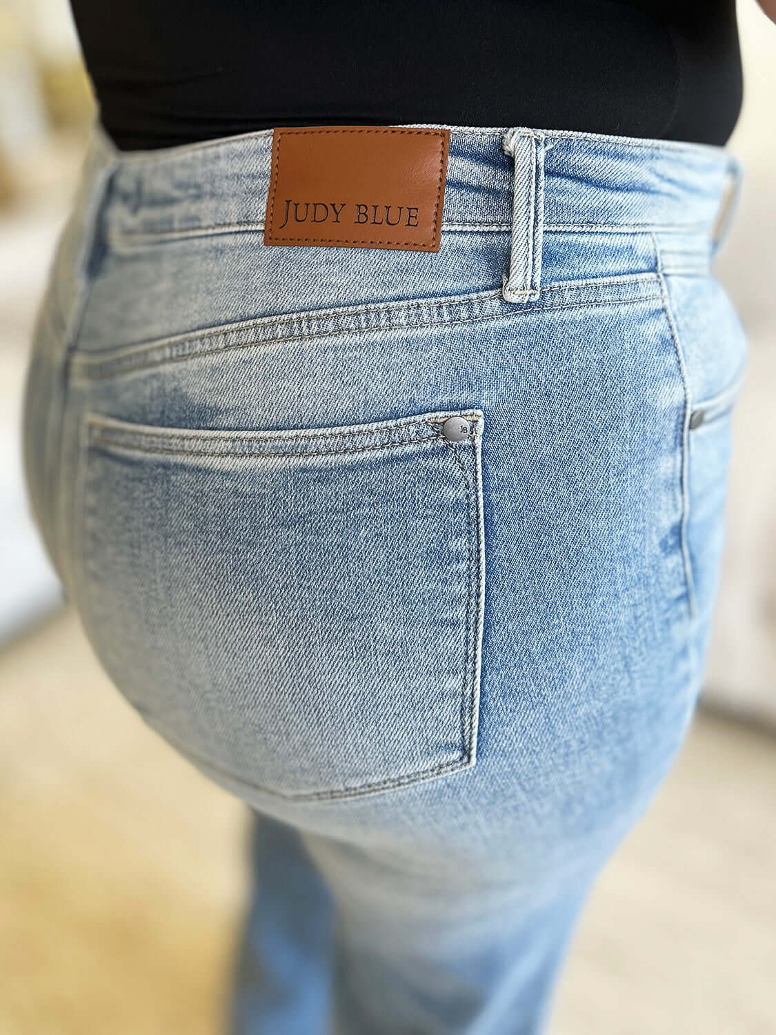 High Waist Wide Leg Judy Blue Jeans featuring back pocket and leather brand patch in light wash denim