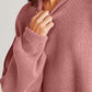 Woman wearing Double Take Side Slit Round Neck Long Sleeve Sweater in blush color