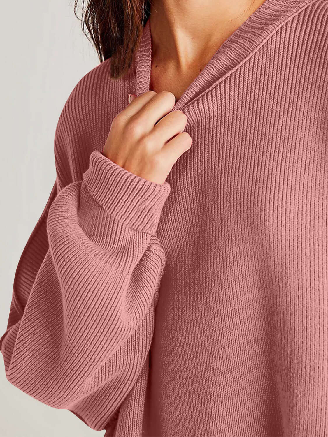 Woman wearing Double Take Side Slit Round Neck Long Sleeve Sweater in blush color