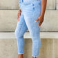 Woman wearing Judy Blue Button Fly Raw Hem Jeans with a casual everyday look.