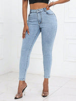 Woman wearing Bella Road High Waist Skinny Jeans with Pockets, light wash, paired with black top and heels.