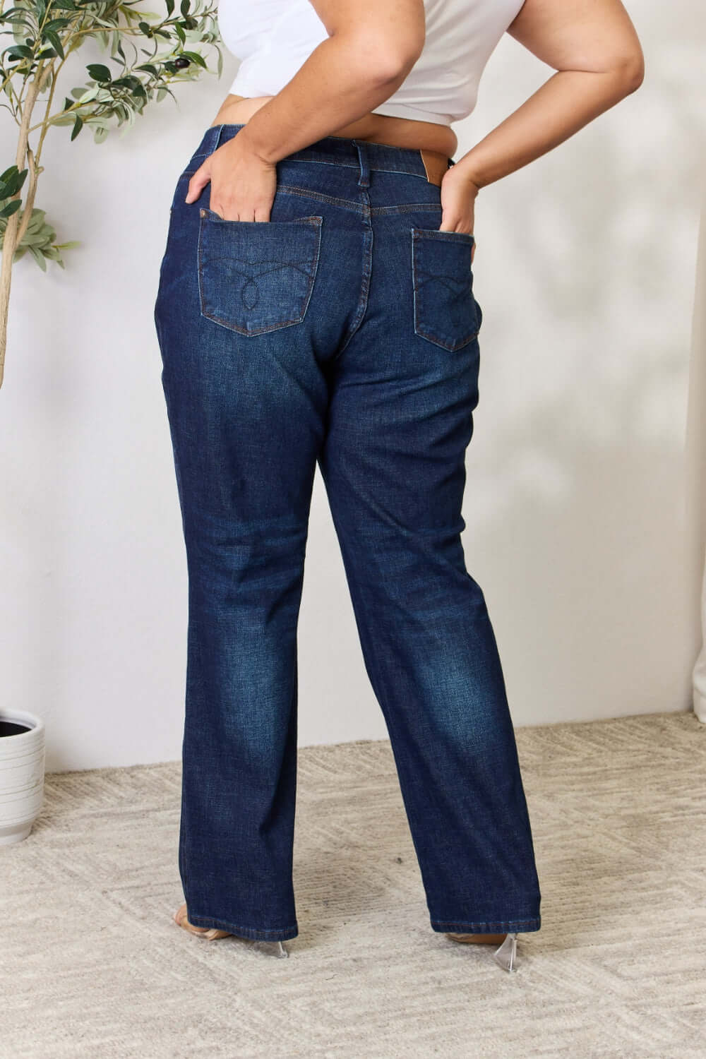 Woman wearing Judy Blue Button-Fly Straight Jeans with high waist and back pockets, showcasing a flattering fit and slightly stretchy material