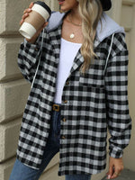 Woman wearing Bella Road Drawstring Plaid Long Sleeve Hooded Jacket holding a coffee cup