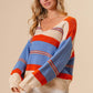 Woman wearing BiBi Multi Color Stripe Scoop Neck Sweater with vibrant stripes and a cozy, flattering fit.