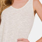 Woman wearing a white Curved Hem Round Neck Tank paired with casual bottoms for a stylish and comfortable summer look.