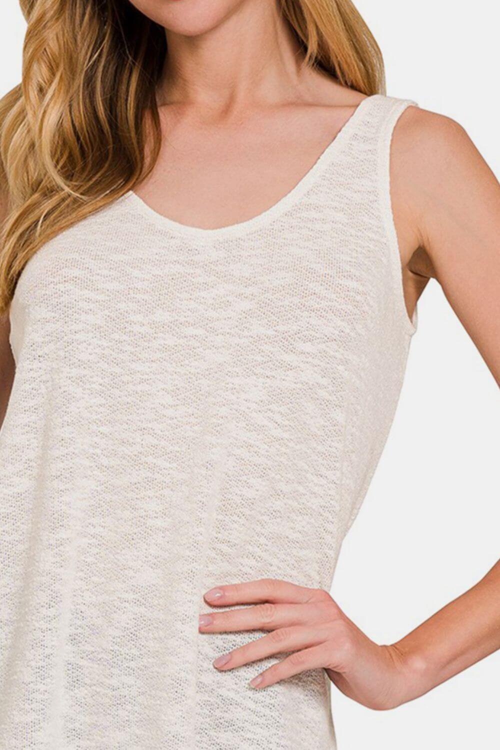 Woman wearing a white Curved Hem Round Neck Tank paired with casual bottoms for a stylish and comfortable summer look.