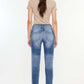 Back view of High Rise Distressed Mom Jeans showcasing flattering high-rise waist and distressed detailing, paired with beige top.