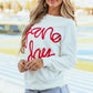 Woman wearing Bella Road Game Day Round Neck Long Sleeve Sweatshirt with red lettering, stylish and perfect for cool game days.