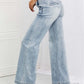 Model wearing Risen high-waisted Luisa Wide Flare Jeans with pockets, showcasing casual style and light wash denim袢