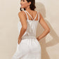 Woman wearing a white drawstring scoop neck sleeveless cover up dress with openwork details, slightly stretchy, made of polyester and spandex.