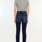 Back view of model wearing Cat's Whiskers Raw Hem High Waist Jeans in dark wash, paired with a grey t-shirt and black heels.