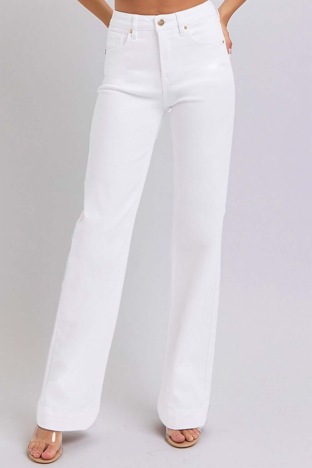 Woman wearing white high waist straight jeans with a flattering silhouette, slightly stretchy and pocketed, by Risen Jeans.