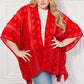 JUSTIN TAYLOR Pom-Pom Asymmetrical Poncho Cardigan in Red at Bella Road