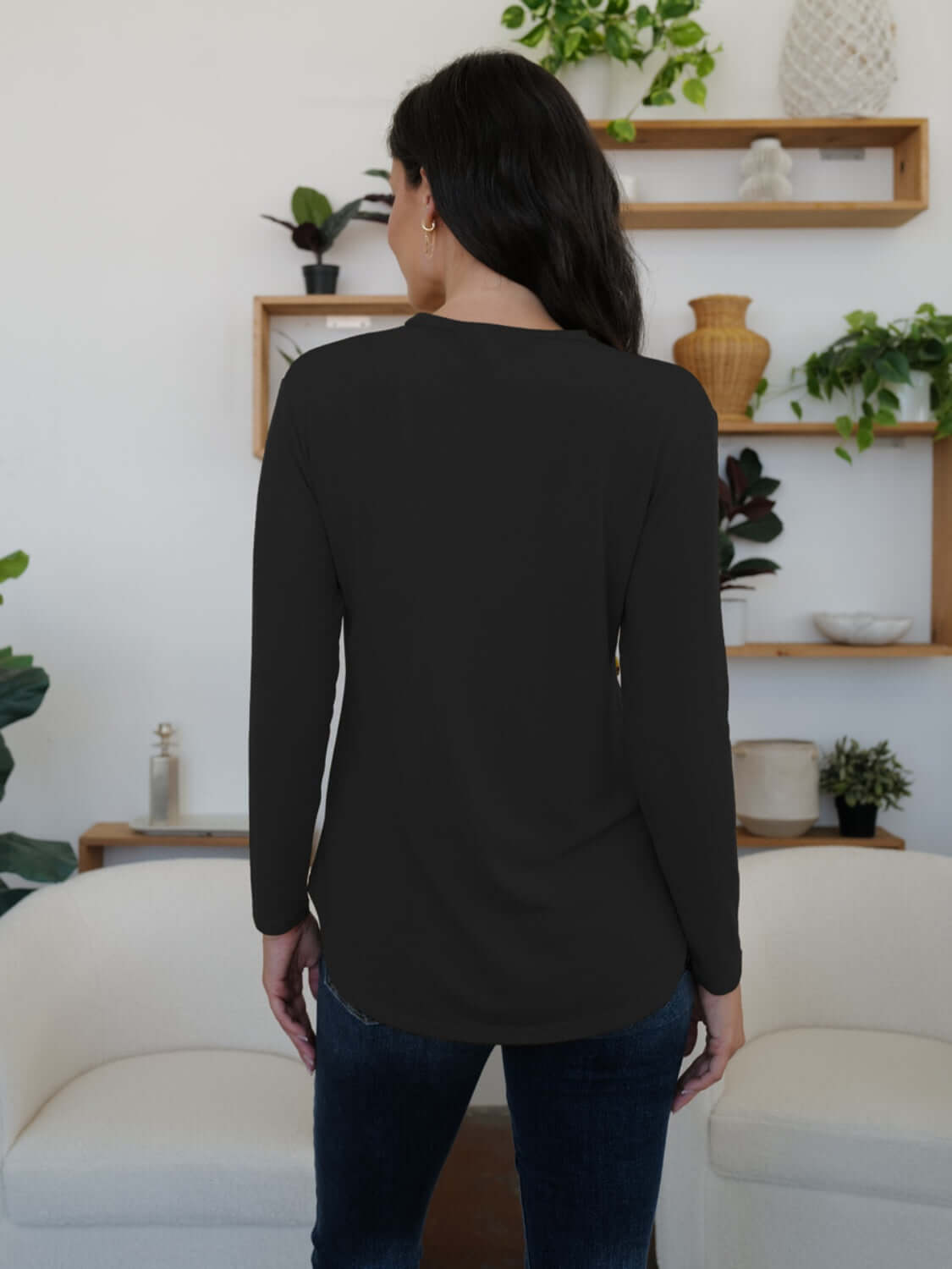 Woman wearing FAM-FAM Round Neck Long Sleeve T-Shirt in black, perfect for casual style, back view.