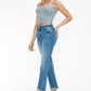 Model wearing bytos Raw Hem Distressed Mid Rise Crop Jeans paired with a gray crop top and stylish heels.