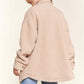 Cozy teddy sherpa shacket with button-down design and curved hem, perfect for layering in style, shown in casual outfit.