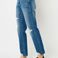 Distressed Slim Judy Blue Jeans with ripped details and a flattering fit, paired with black sneakers.