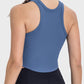 Back view of Millennia Round Neck Racerback Active Tank in blue, showcasing its ribbed texture and crop style.