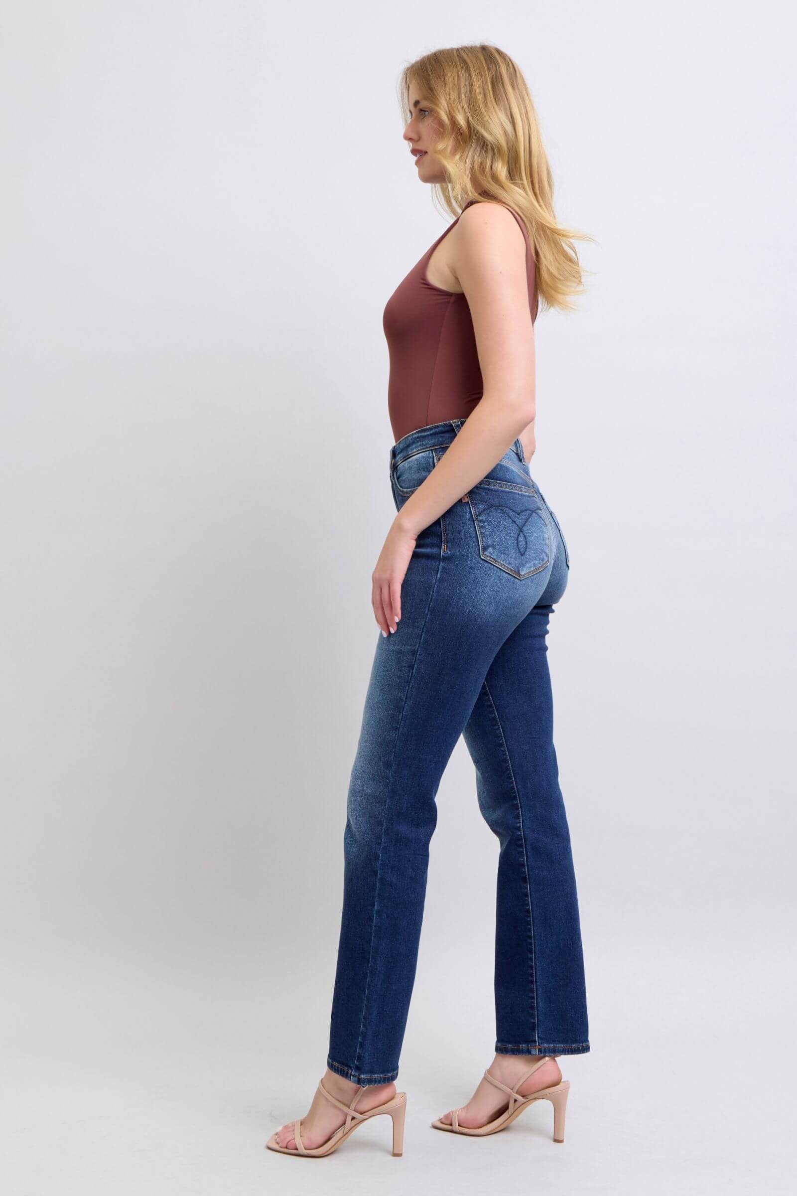 Judy Blue washed straight leg jeans with pockets showcased on a model, offering a flattering silhouette and casual style.