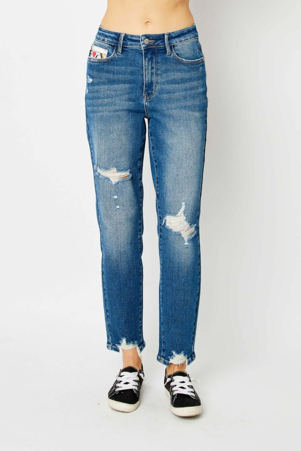 Distressed slim jeans by Judy Blue Jeans with trendy design, shown with sneakers for a relaxed, stylish look.