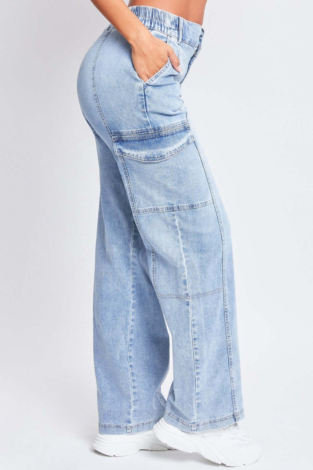 High-rise straight leg jeans with elastic waistband, front seams, patch pockets, and side cargo pockets by YMI Jeans.