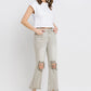 Woman wearing Lovervet Distressed Raw Hem Cropped Flare Jeans with a white top and high heels.