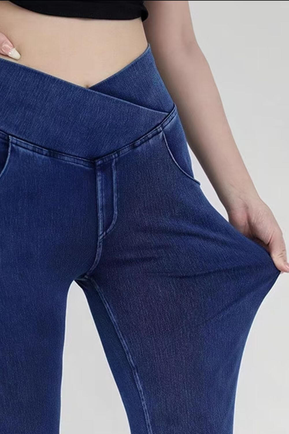 Close-up of a person showing the highly stretchy waist of Basic Bae Bootcut Jeans, highlighting comfort and flexibility.