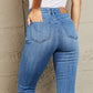 Rear view of model wearing Janavie high waisted pull-on skinny jeans with release hem detailing and premium stretch denim fabric.