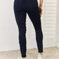 Back view of woman wearing Garment Dyed Tummy Control Skinny Jeans by Judy Blue Jeans showing off slimming silhouette.