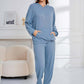 Woman wearing Bella Road light blue hoodie and pants set with pockets, cozy and stylish for lounging or errands, relaxed fit.