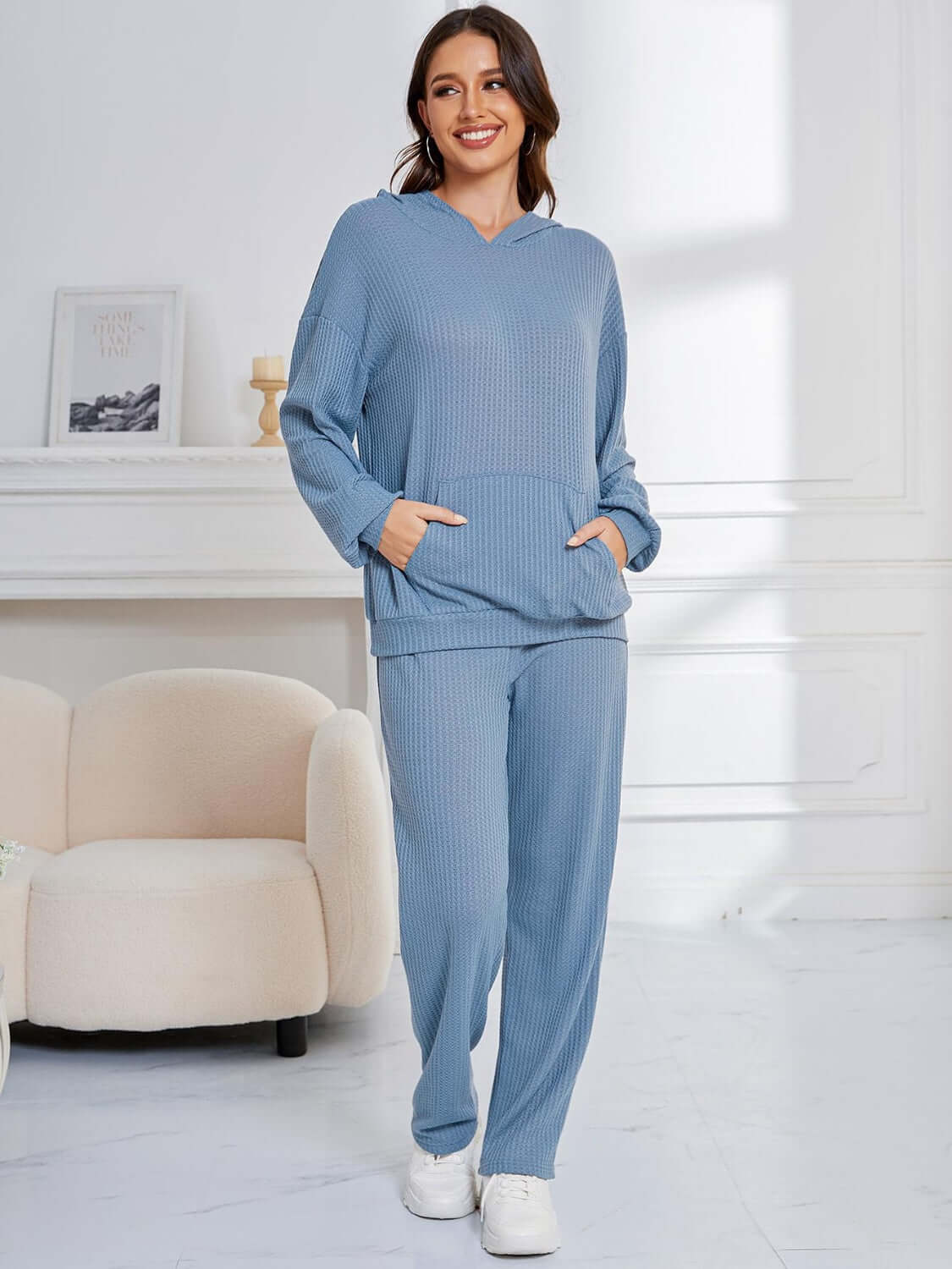 Woman wearing Bella Road light blue hoodie and pants set with pockets, cozy and stylish for lounging or errands, relaxed fit.