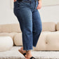 Woman wearing Tummy Control High Waist Raw Hem Jeans from RFM Jeans, showcasing a stylish and flattering fit with distressed and trendy raw hem detailing.