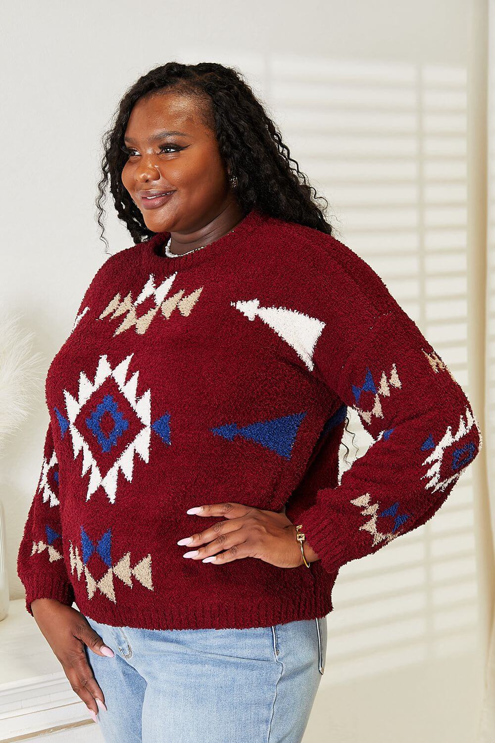 Woman wearing HEYSON Full Size Aztec Soft Fuzzy Sweater with vibrant pattern and cozy texture.