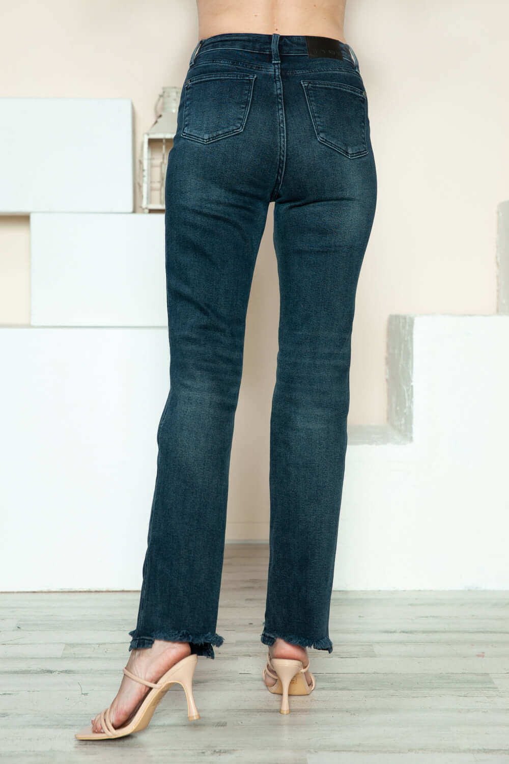 Back view of Judy Blue straight jeans with stylish button fly and distressed hem, perfect for trendy casual wear.