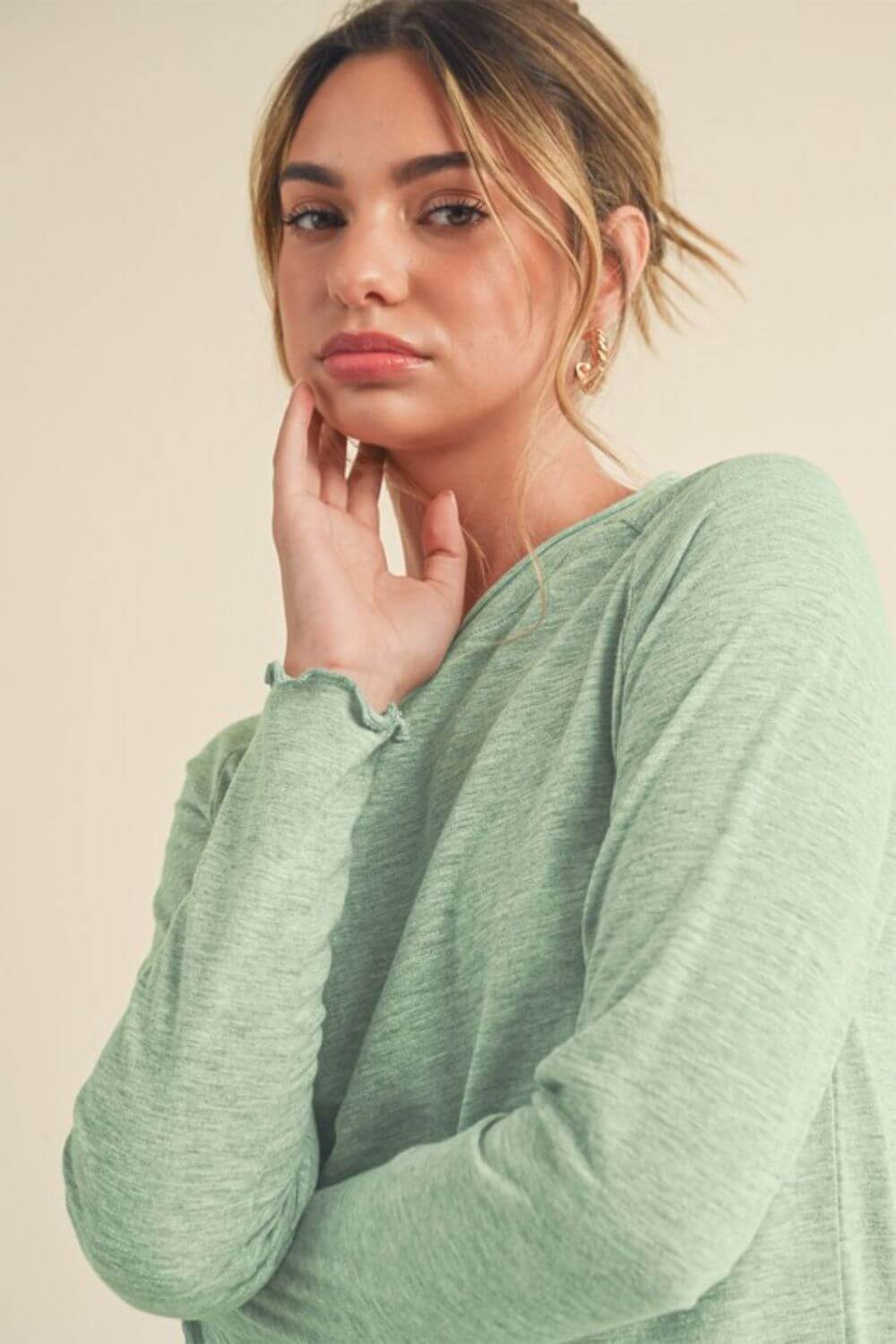 Model wearing a mint green Lettuce Hemline Round Neck Raglan Sleeve T-Shirt, featuring a relaxed fit and playful design.