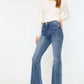 Model wearing Cat's Whiskers High Waist Flare Jeans with white top and black heels for a chic, retro-inspired look.