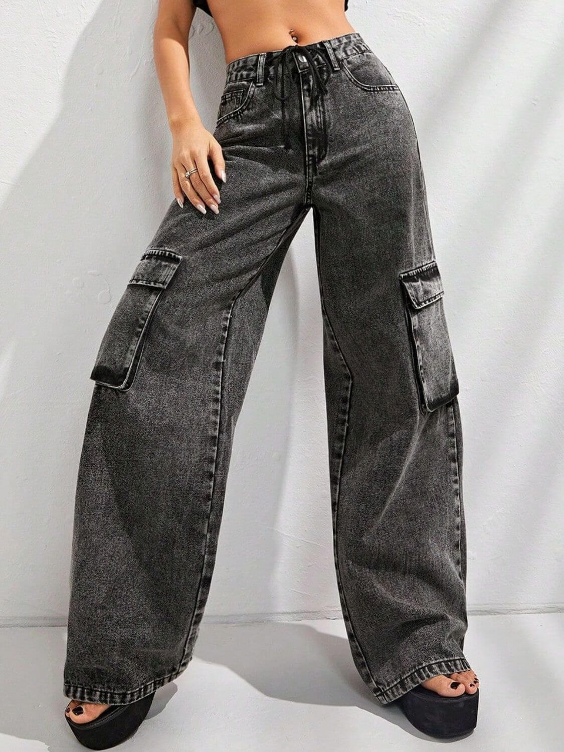 Woman wearing Bella Road Wide Leg Jeans with Pockets, featuring a faded black color and cargo pockets, perfect for casual street style.