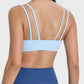 Back view of a model wearing a light blue double strap cami, perfect for workouts and casual wear.