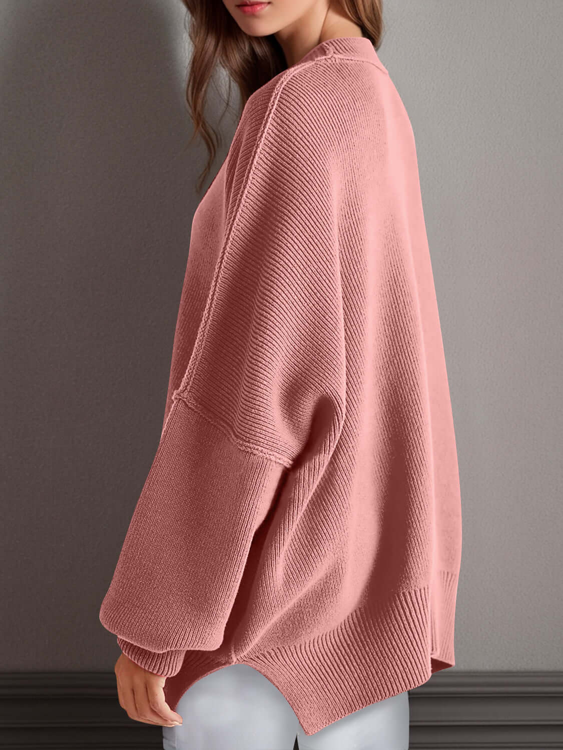 Pink side slit round neck long sleeve sweater with moderate stretch, made of 95% cotton and 5% polyester. Perfect for a fun, cozy look.