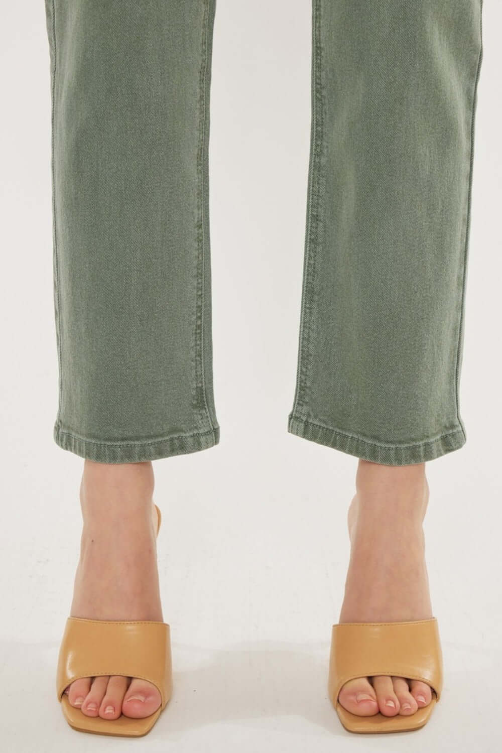 Olive Kancan ultra high-rise straight jeans with tan heels, highlighting vintage style and comfortable stretch denim.